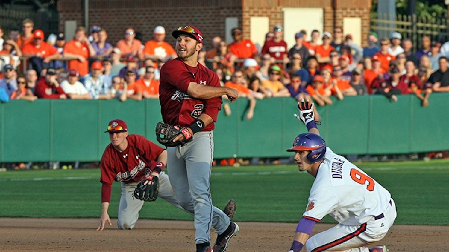 South Carolina Gamecocks&apos; Max Schrock completes a double play against Clemson at Doug Kingsmore Stadium in Columbia, S.C., on Sunday, March 2, 2014. (Dwayne McLemore/The State/MCT)