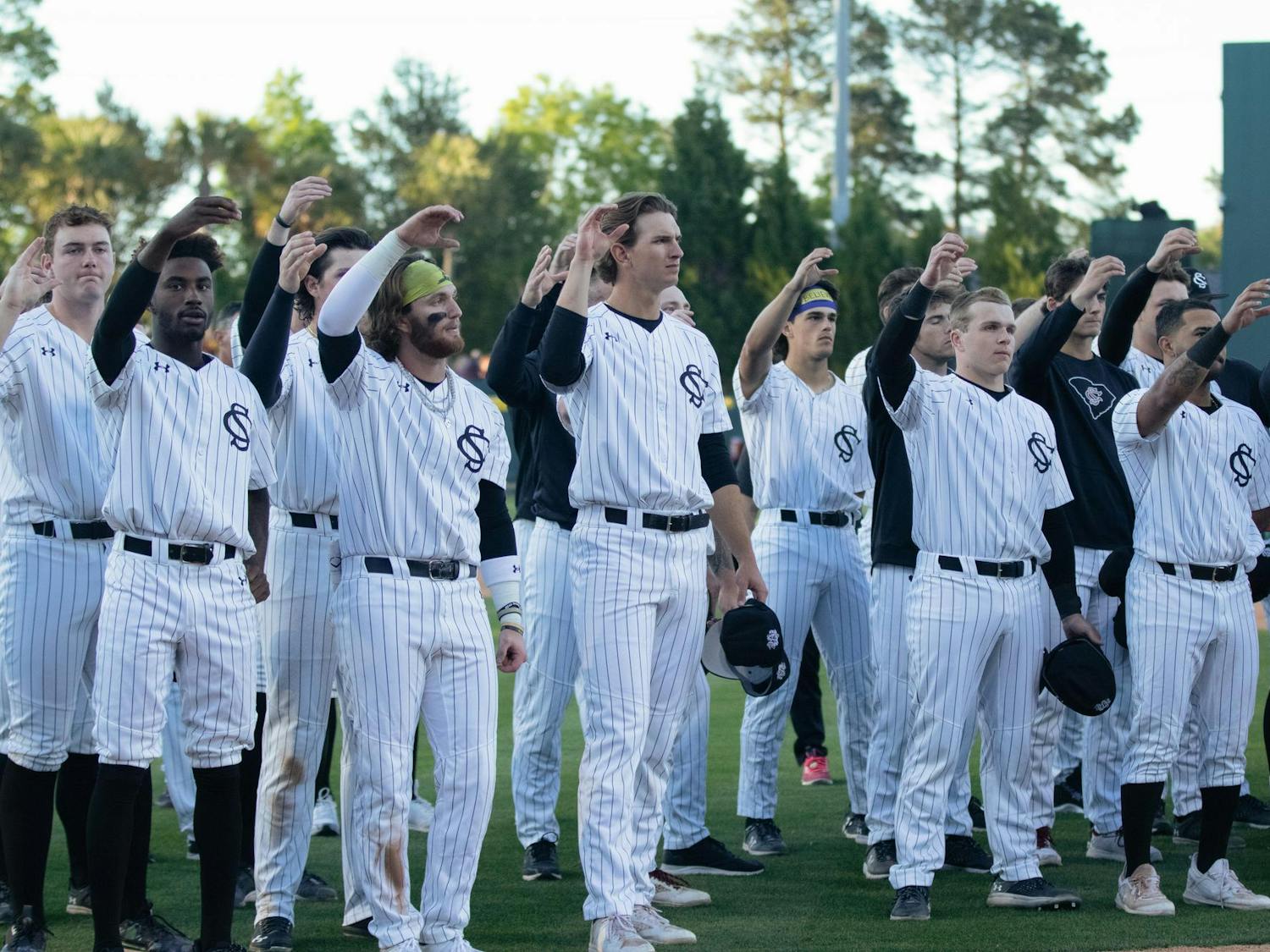 University of South Carolina baseball players stand together and make a toast while the alma mater plays following their loss to Texas A&amp;M on April 6, 2024. The Gamecocks are 21-10 overall on the season.