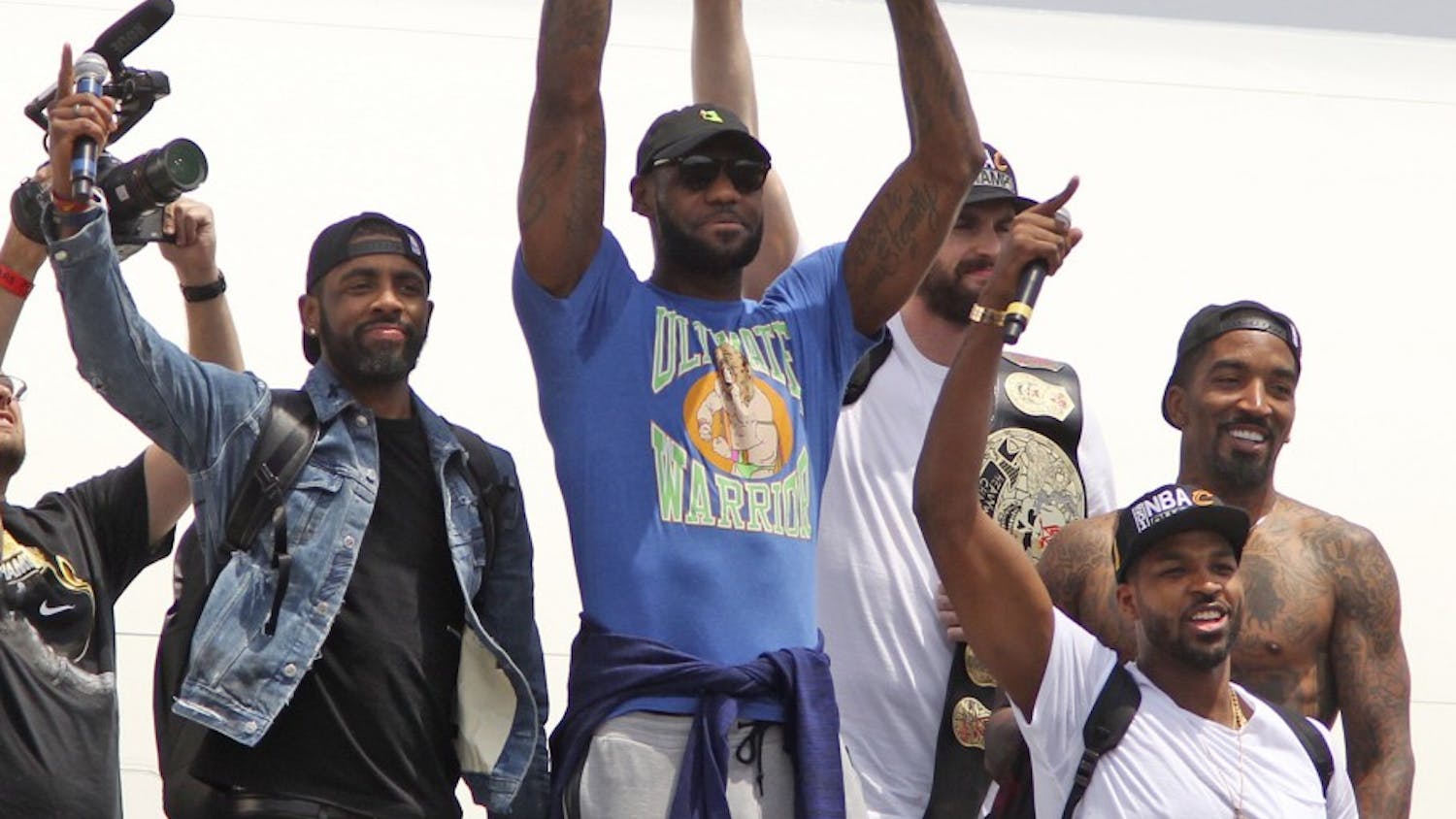 Cleveland Cavaliers' LeBron James holds up the NBA Championship trophy alongside teammates on JUne 20, 2016 after arriving in Cleveland, Ohio. Joining James are Kyrie Irving, left, Kevin Love, J.R. Smith and Tristan Thompson as they arrive at Atlantic Aviation. (Mike Cardew/Akron Beacon Journal/TNS )