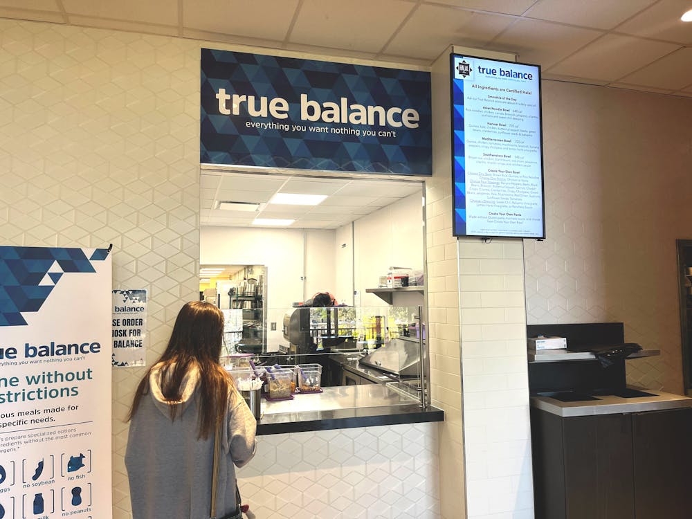 <p>A student waits for her meal to be prepared outside of Russell House’s True Balance restaurant on March 19, 2023. 鶹С򽴫ý has recently introduced kosher and halal food options to different dining locations on campus.</p>