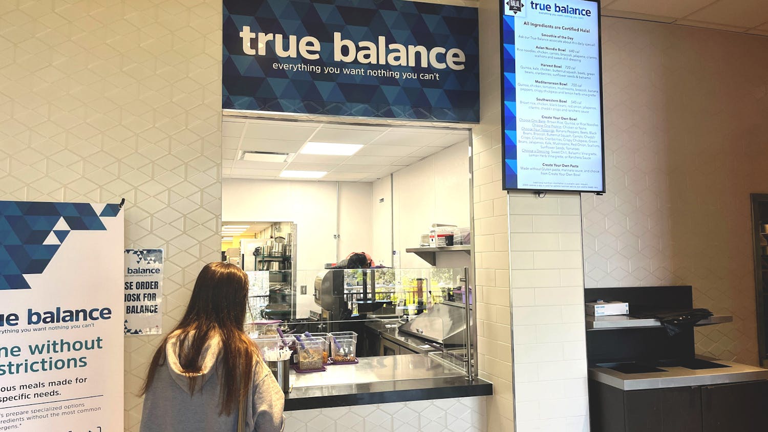 A student waits for her meal to be prepared outside of Russell House’s True Balance restaurant on March 19, 2023. USC has recently introduced kosher and halal food options to different dining locations on campus.