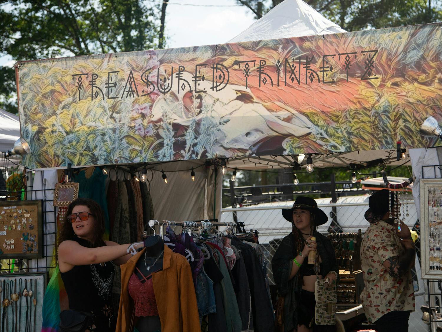 Clothing vendors Treasured Trinket sells items to customers on April 22, 2023, at the Hidden City Music Festival. Customers at the festival could only pay digitally, making it a completely cashless exchange.