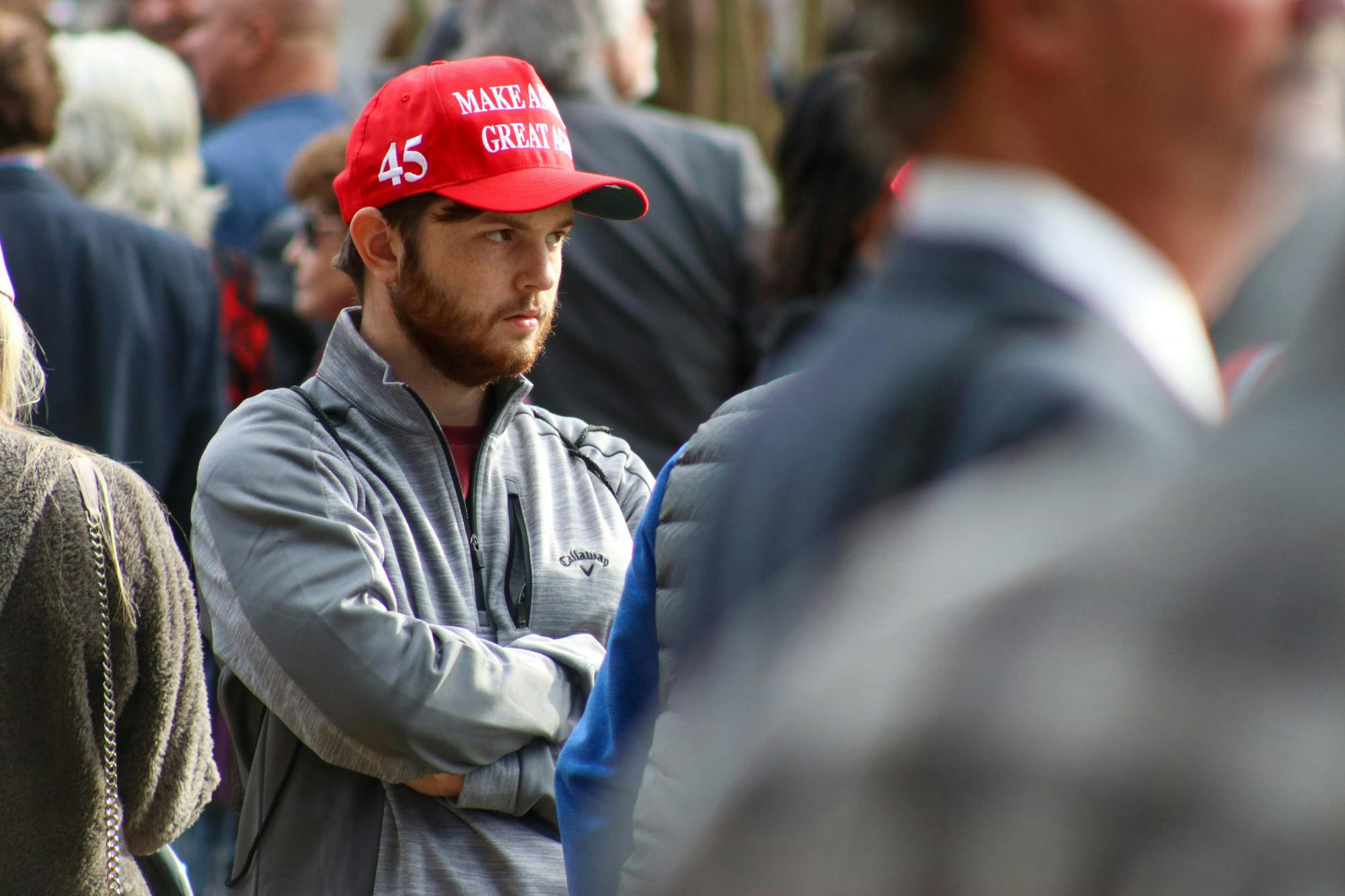 A man wears a MAGA hat as he stands outside of the Statehouse during Trump's campaign visit on Jan. 28, 2023. Attendees arrived in the early afternoon, hoping to hear from their ideal 2024 presidential candidate.&nbsp;