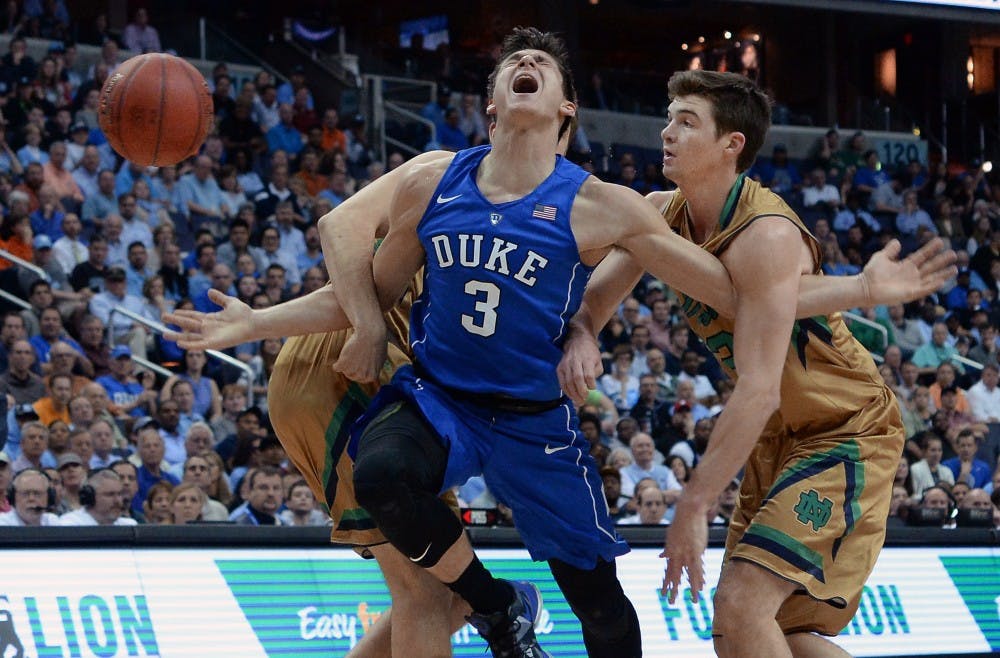 Duke guard Grayson Allen (3) is fouled by Notre Dame forward V.J. Beachem (3) during the first half of play in the quarterfinals of the 2016 New York Life ACC Tournament at the Verizon Center on March 10, 2016 in Washington, D.C. (Chuck Liddy/Raleigh News & Observer/TNS) 