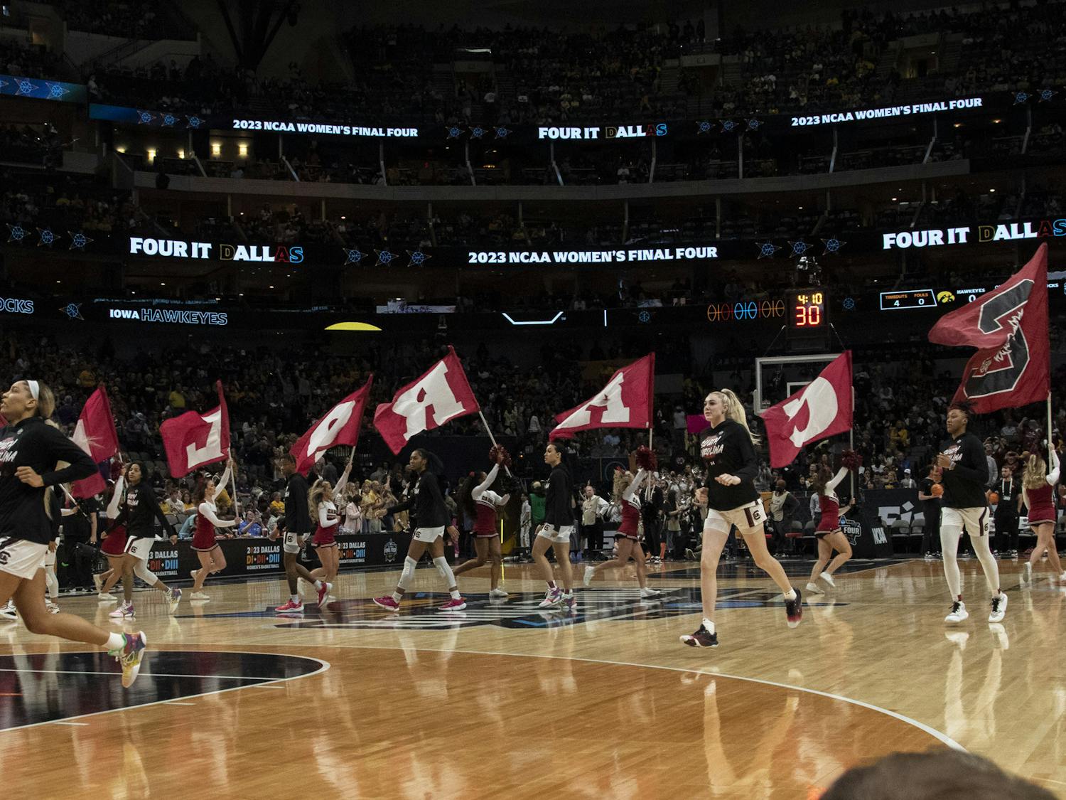 The Gamecock women's basketball team takes charge and storms the court with the support of the USC cheerleading team for its Final Four match against the University of Iowa on March 31, 2023. The Gamecocks fell to the Hawkeyes 77-73.