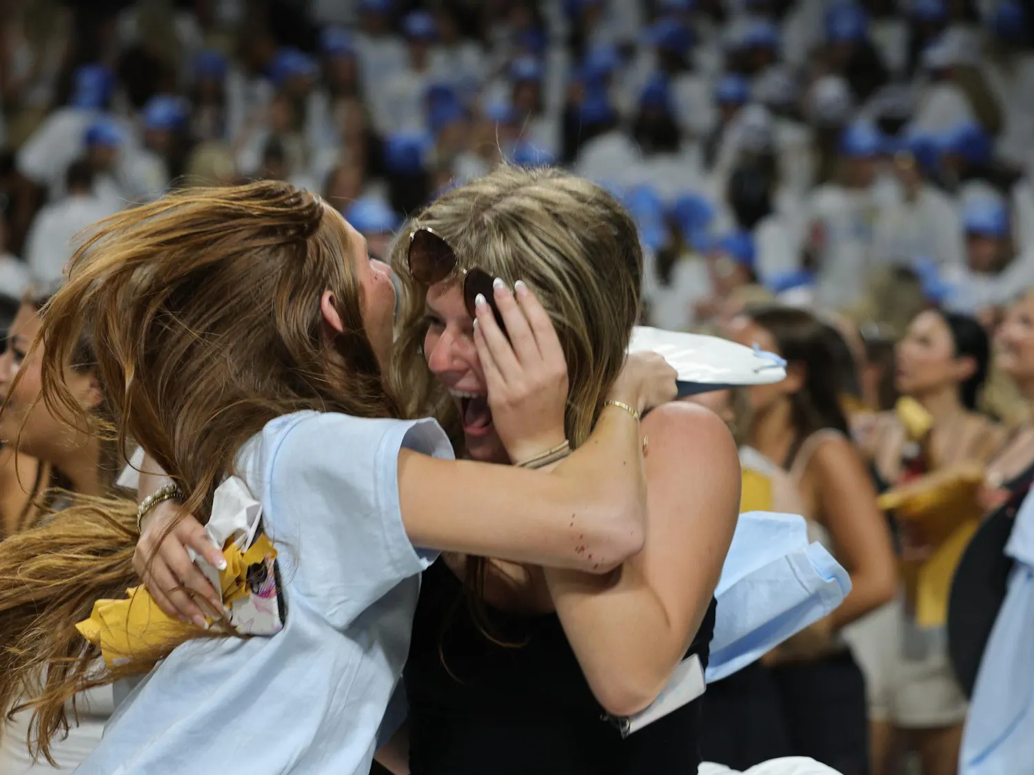 A new member of Pi Beta Phi is greeted with an embrace during Bid Day on Aug. 16, 2026, at Colonial Life Arena. The moment came as students rushed across the arena to meet their new sororities.