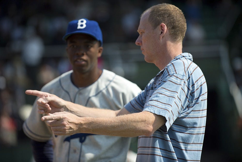 Chadwick Boseman (left) and director Brian Helgeland are seen on the set of Warner Bros. Pictures and Legendary Pictures drama &quot;42,&quot; a Warner Bros. Pictures release. (D. Stevens/Warner Bros/MCT)