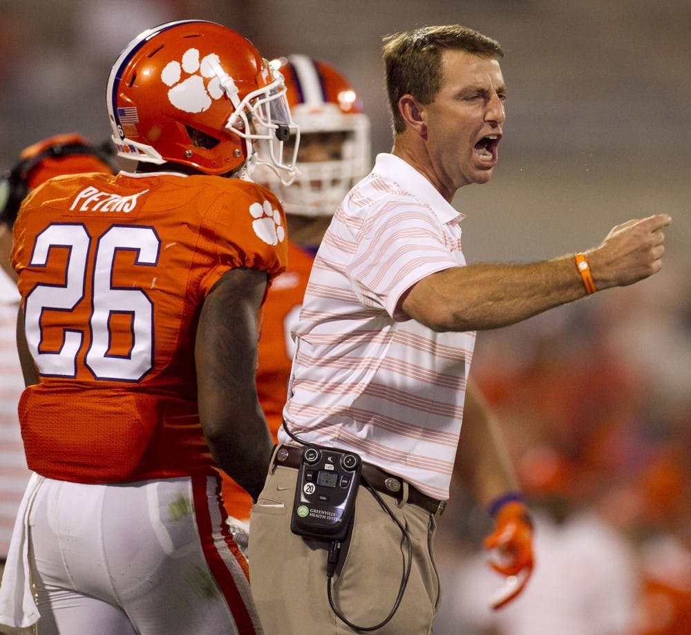 Clemson head coach Dabo Swinney yells at his defensive unit during a timeout in the fourth quarter against North Carolina at Memorial Stadium in Clemson, S.C., on Saturday, Sept. 27, 2014. Clemson won, 50-35. (Robert Willett/Raleigh News &amp; Observer/MCT)