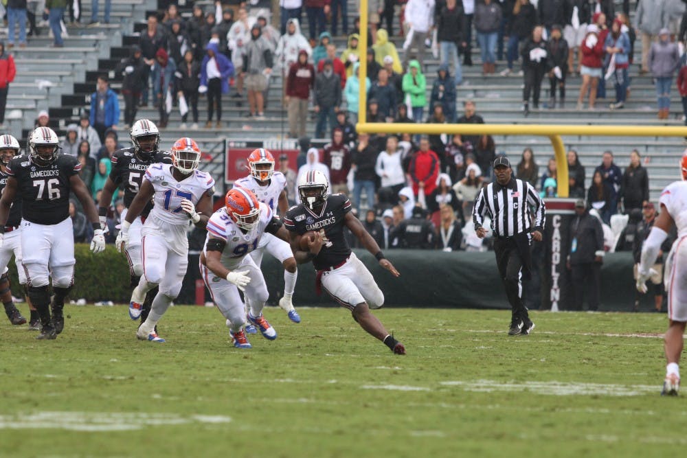 Senior running back Tavien Feaster outruns Florida defenders during the game Saturday.