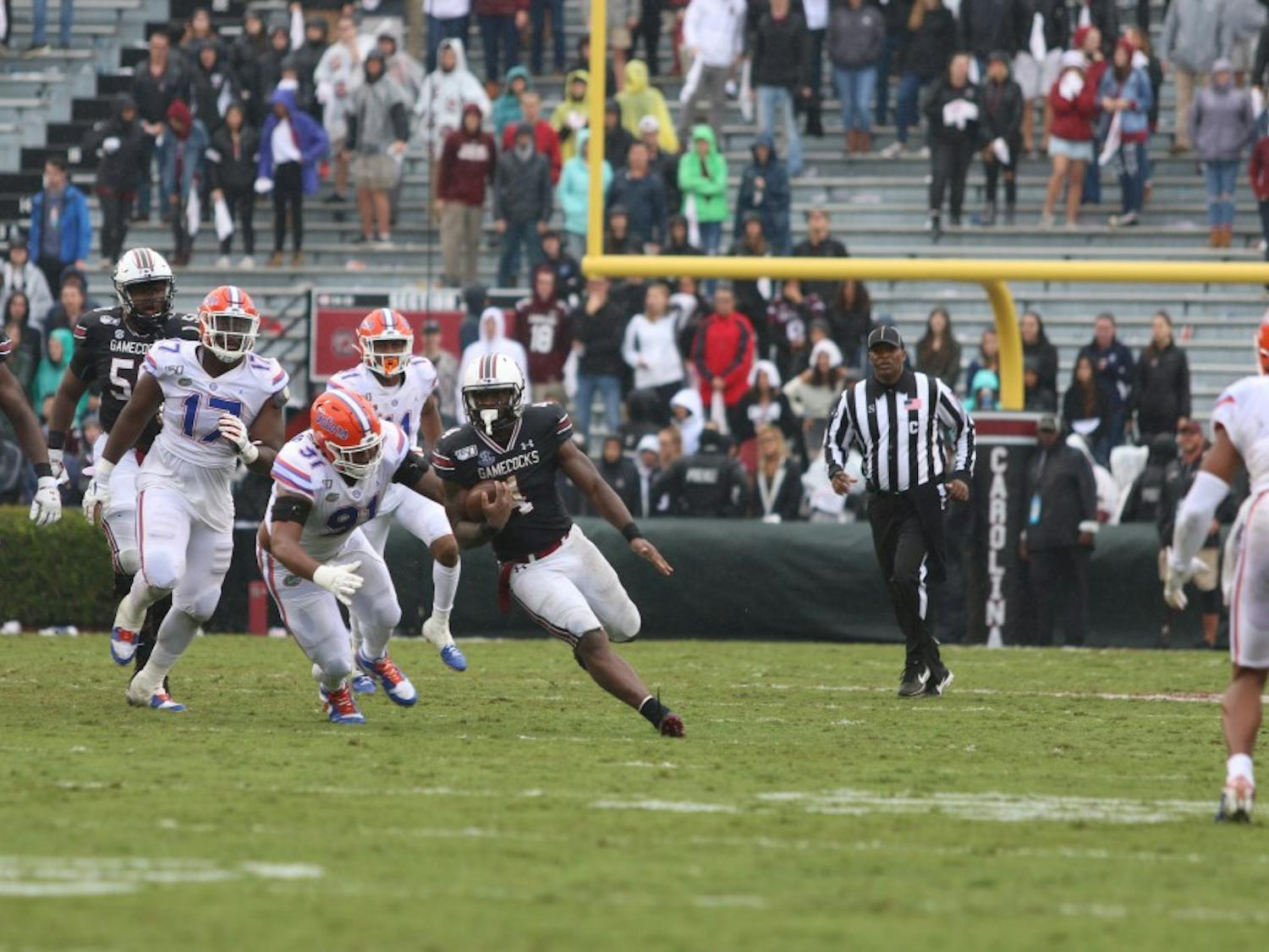 Senior running back Tavien Feaster outruns Florida defenders during the game Saturday.