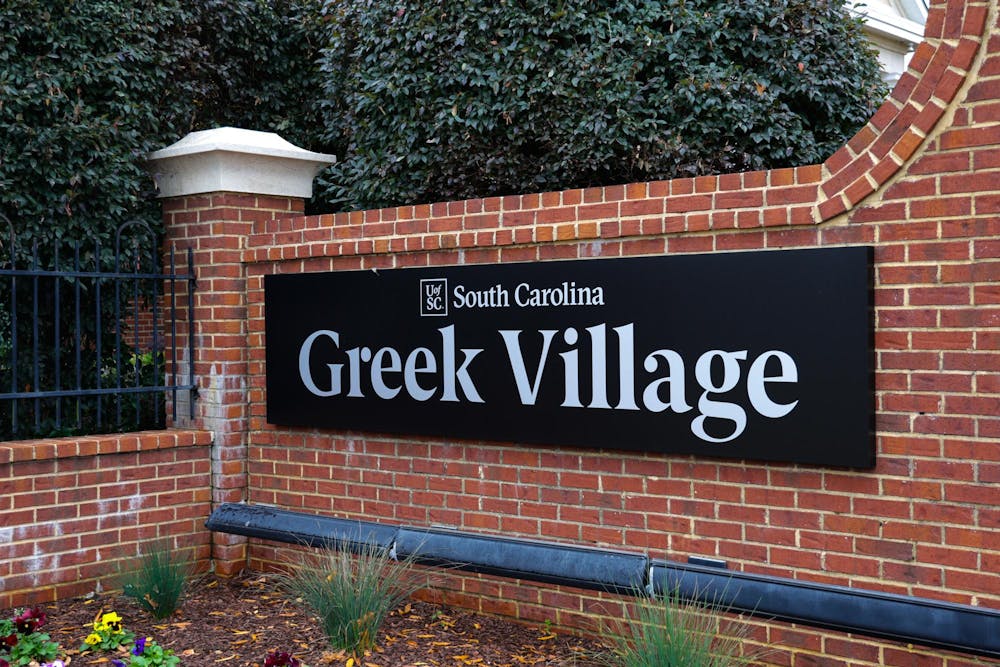 <p>The Greek Village sign stands on Blossom Street on Dec. 2, 2023. Greek Village is currently home to 13 sororities and seven fraternities.</p>