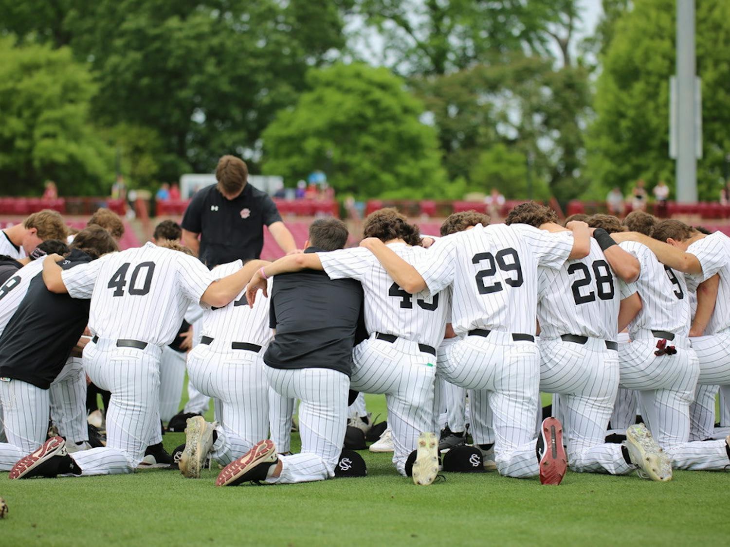 The South Carolina Gamecocks huddle together in prayer before the second game of an SEC series against LSU on April 7, 2023. The Gamecocks defeated the Tigers 13-5 in the first game of the series but dropped game two 8-7.&nbsp;