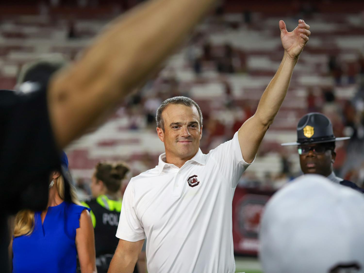 Head football coach Shane Beamer holds up his hand during the alma mater after South Carolina defeated Furman 47-21 in its first home game of the 2023 season. Beamer is now 16-12 in just over two seasons as the Gamecocks' coach.