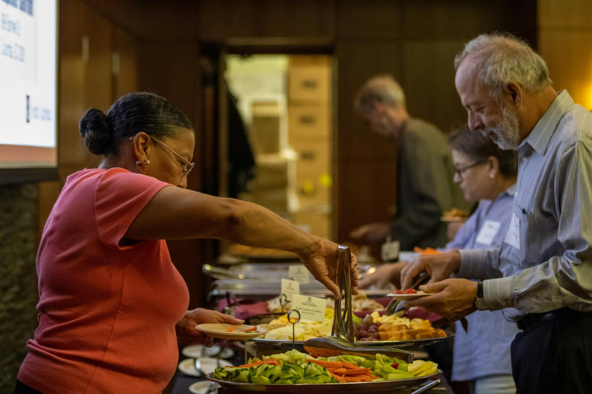 Guests help themselves to refreshments and other items before the screening of The U.S. and The Holocaust on September 14, 2022, in the Capstone Ballroom. The event was brought together by South Carolina ETV and the Anne Frank Center.