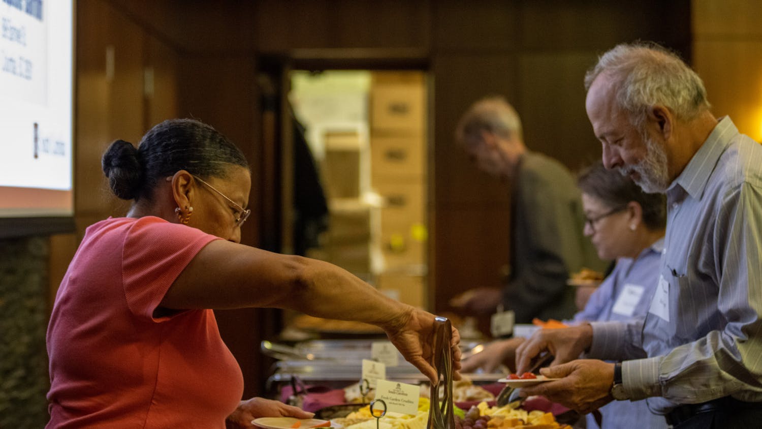 Guests help themselves to refreshments and other items before the screening of The U.S. and The Holocaust on September 14, 2022, in the Capstone Ballroom. The event was brought together by South Carolina ETV and the Anne Frank Center.