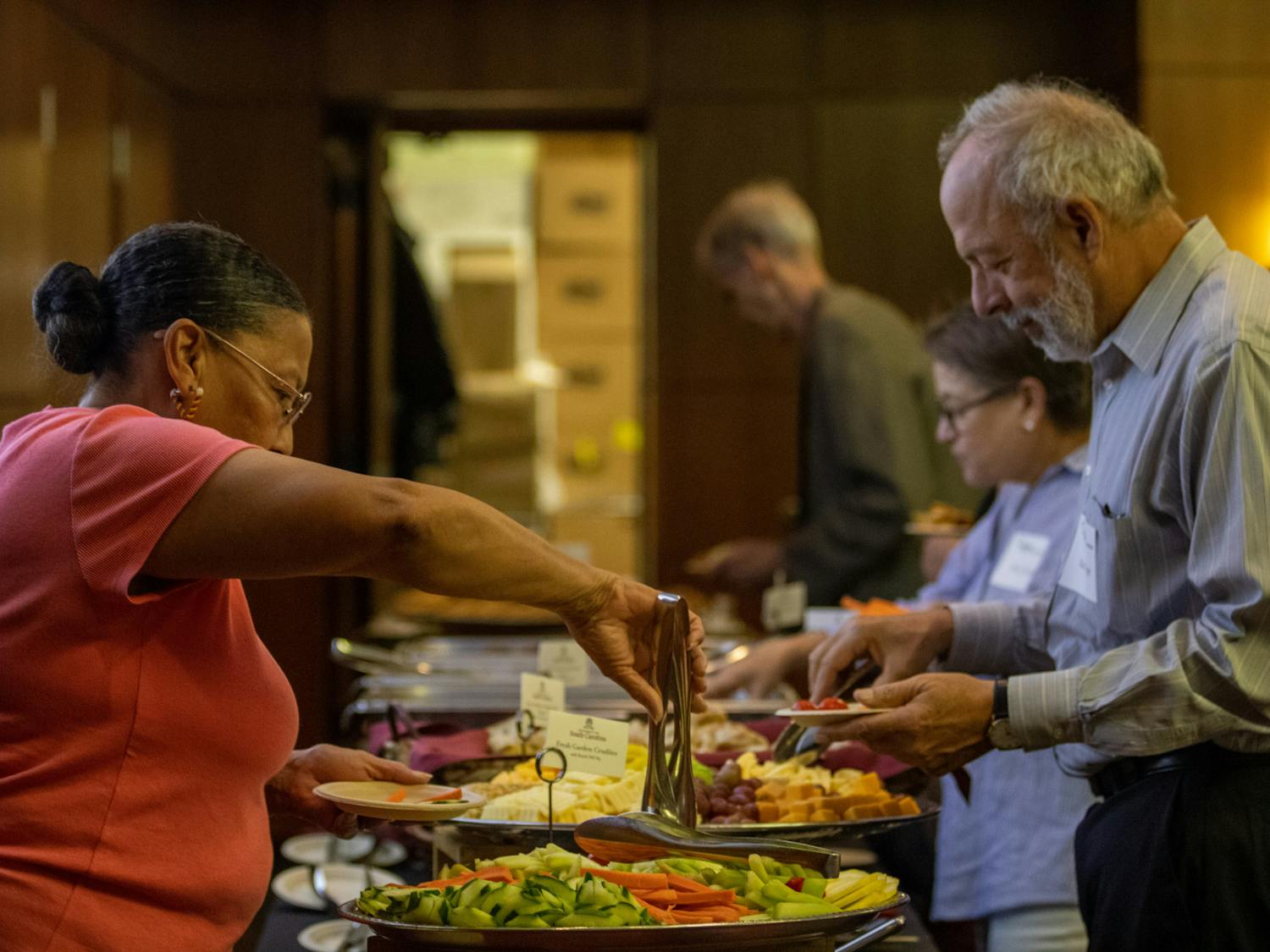 Guests help themselves to refreshments and other items before the screening of The U.S. and The Holocaust on September 14, 2022, in the Capstone Ballroom. The event was brought together by South Carolina ETV and the Anne Frank Center.