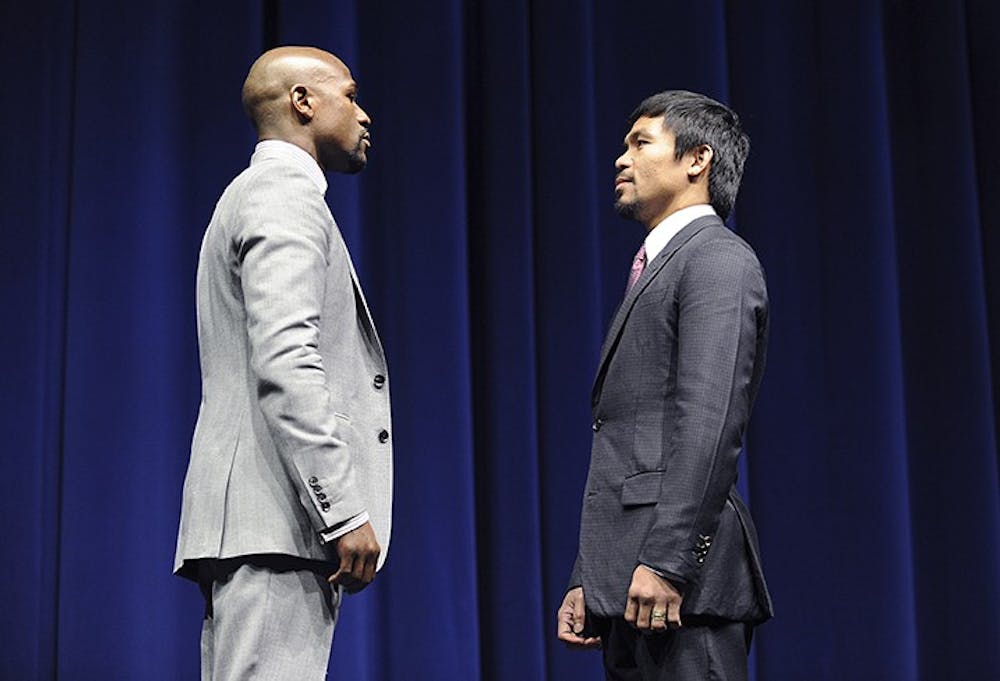 Floyd Mayweather, left, and Manny Pacquiao square off during a news conference at the Nokia Theatre in Los Angeles on Wednesday, March 11, 2015. The two welterweights will meet in the ring on May 2, 2015.(Wally Skalij/Los Angeles Times/TNS)