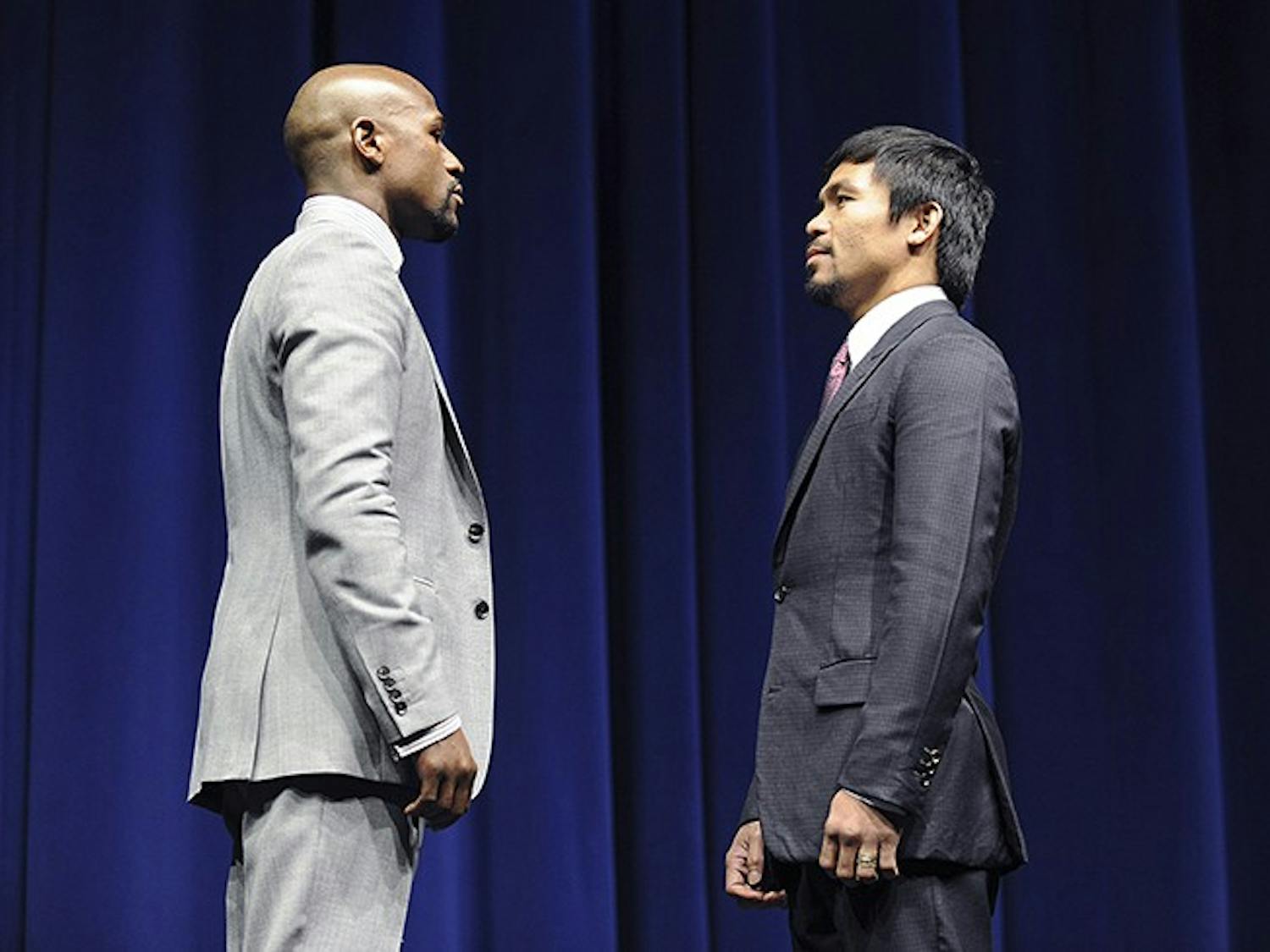 Floyd Mayweather, left, and Manny Pacquiao square off during a news conference at the Nokia Theatre in Los Angeles on Wednesday, March 11, 2015. The two welterweights will meet in the ring on May 2, 2015.(Wally Skalij/Los Angeles Times/TNS)
