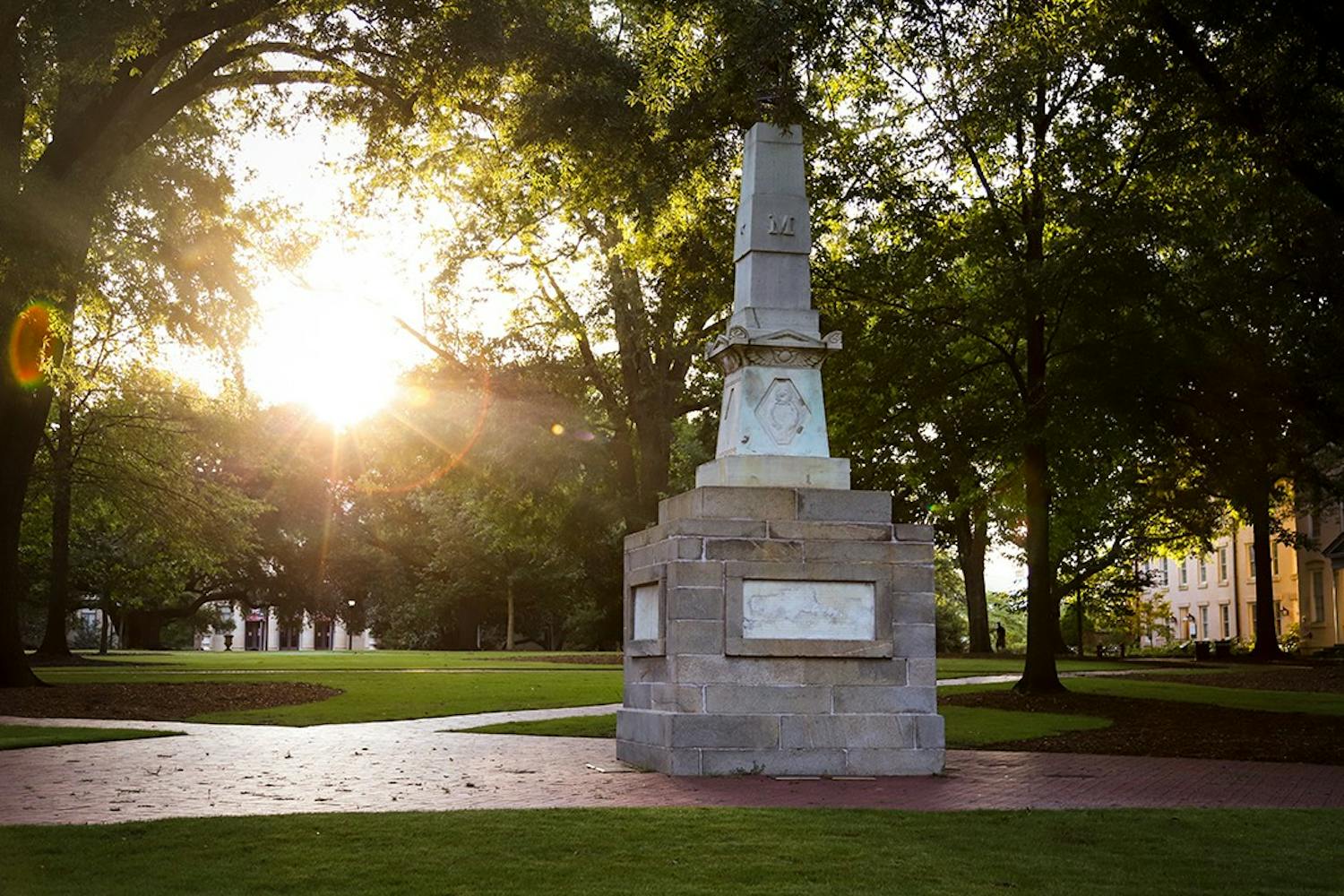 The sun rises behind the Maxcy monument on the Horseshoe.&nbsp;