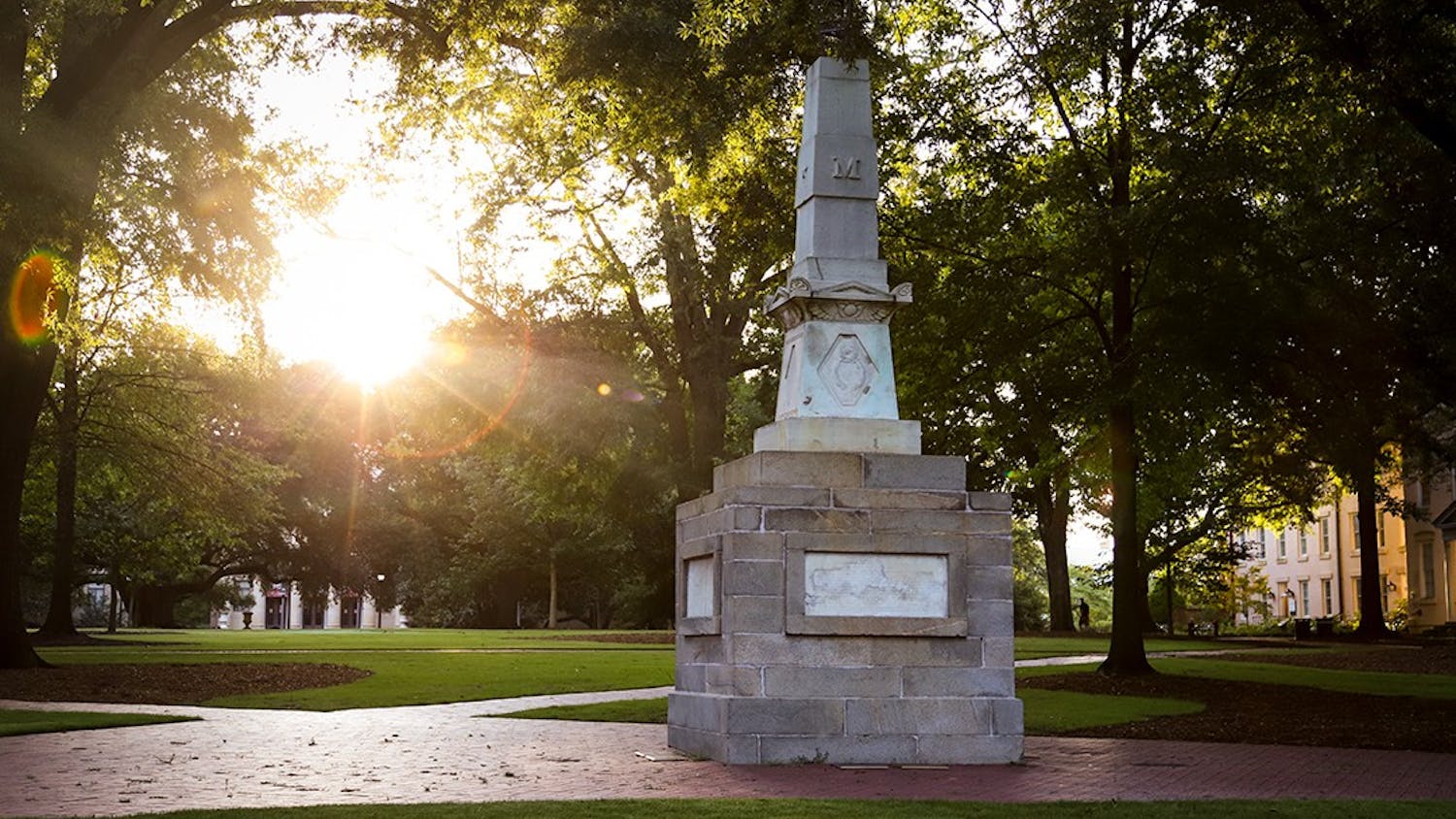 The sun rises behind the Maxcy monument on the Horseshoe. 
