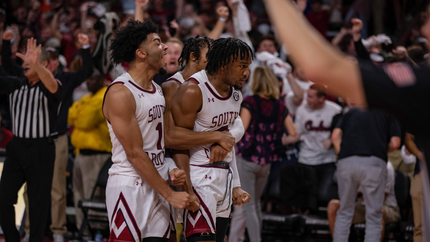 Senior guard Chico Carter is embraced by junior guard Meechie Johnson alongside sophomore guard Jacobi Wright after making the game winning shot against Clemson on Nov. 11, 2022. The Gamecocks beat the Tigers 60-58 in a highly anticipated back-and-forth match.