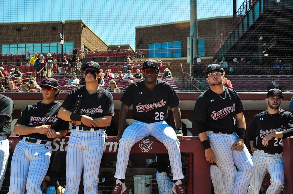 <p>FILE—Freshman outfielder Thad Ector and players from the baseball team sit along dugout prior to their game against Vanderbilt.</p>