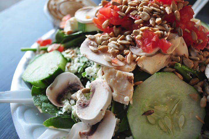 Spinach salad with chicken, mushrooms, tomato, cucumber, feta cheese, sunflower seeds, and house made dressing.
