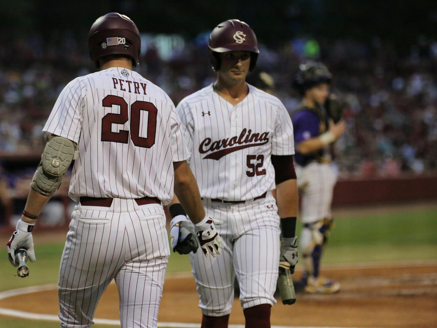 Freshman outfielder Ethan Petry high fives junior first baseman Gavin Casas as he walks up to the plate to hit for the Gamecocks. No. 6 South Carolina won the first game of a three-game series 13-5 against No. 1 LSU on April 6, 2023, at Founders Park.