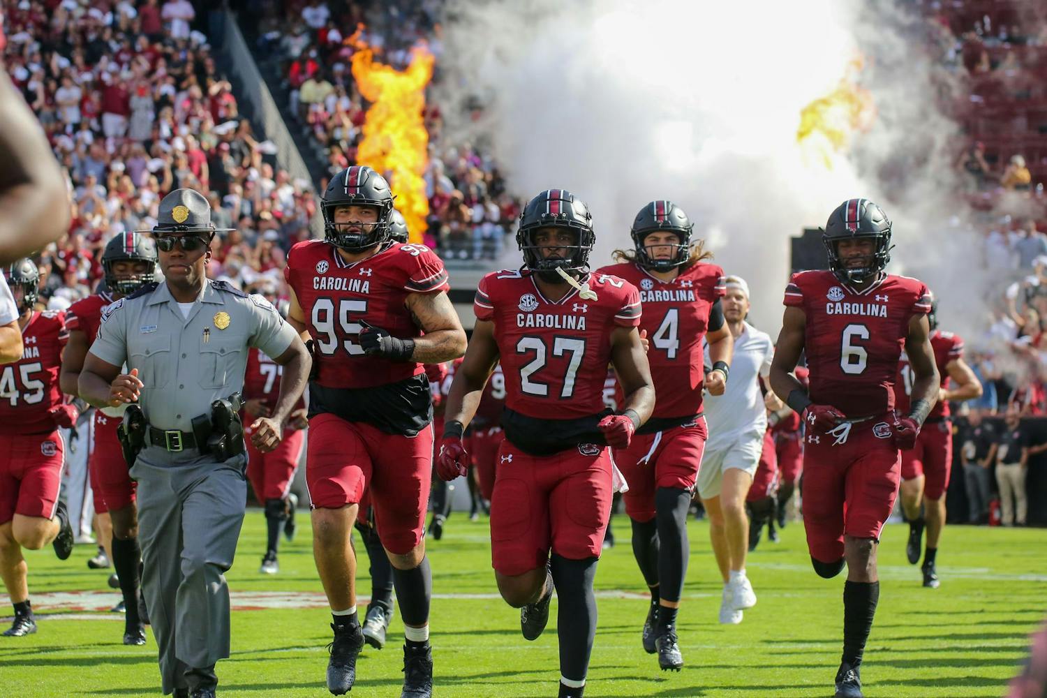 FILE - Redshirt junior defensive tackle Alex Huntley, sixth-year running back D.J. Twitty, redshirt sophomore quarterback Colten Gauthier and graduate tight end Joshua Simon run onto the field before South Carolina’s game against Florida on Oct. 14, 2023, at Williams-Brice Stadium. The Gamecocks lost to the Gators 41-39.