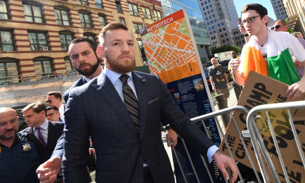 Mixed martial arts fighter Conor McGregor, center, arrives at Brooklyn Supreme Court on Thursday, June 14, 2018 in New York, N.Y., in connection with his alleged April attack on a bus at Barclays Center. on July 26, 2018, McGregor pleaded guilty to his role in starting a fight at the Center.  (Marcus Santos/New York Daily News/TNS)