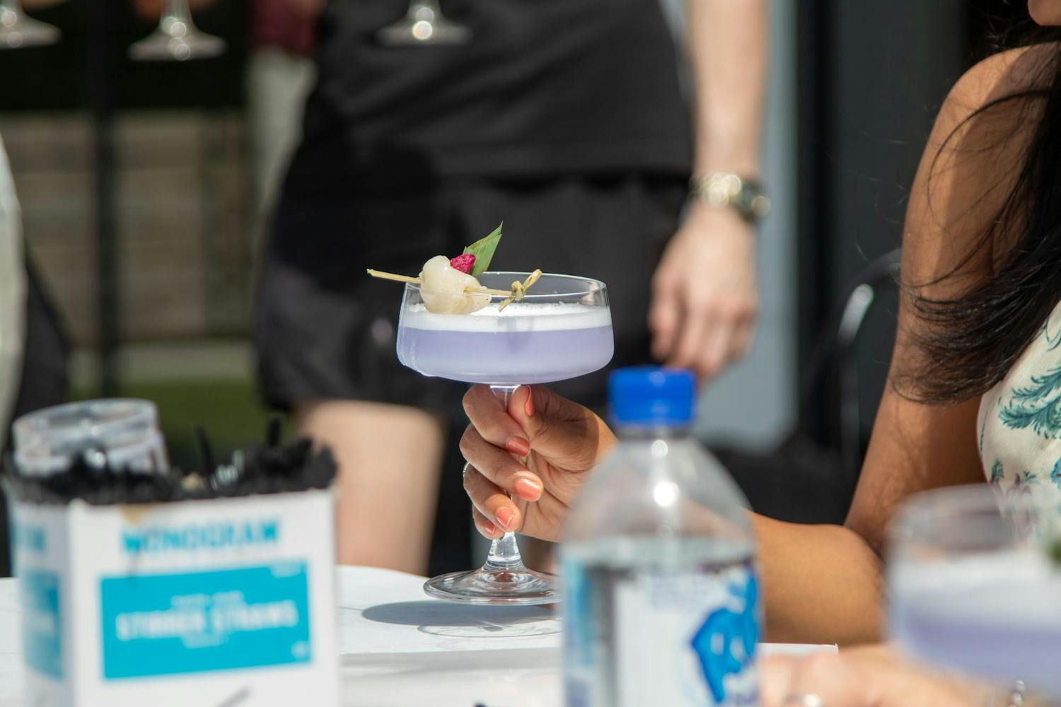 Shalini Kanuganti holds one of the contestants' drinks during the competition on June 9, 2024. The Capital City Cocktail Competition was hosted on the rooftop Palmetto Patio, overlooking Main Street.