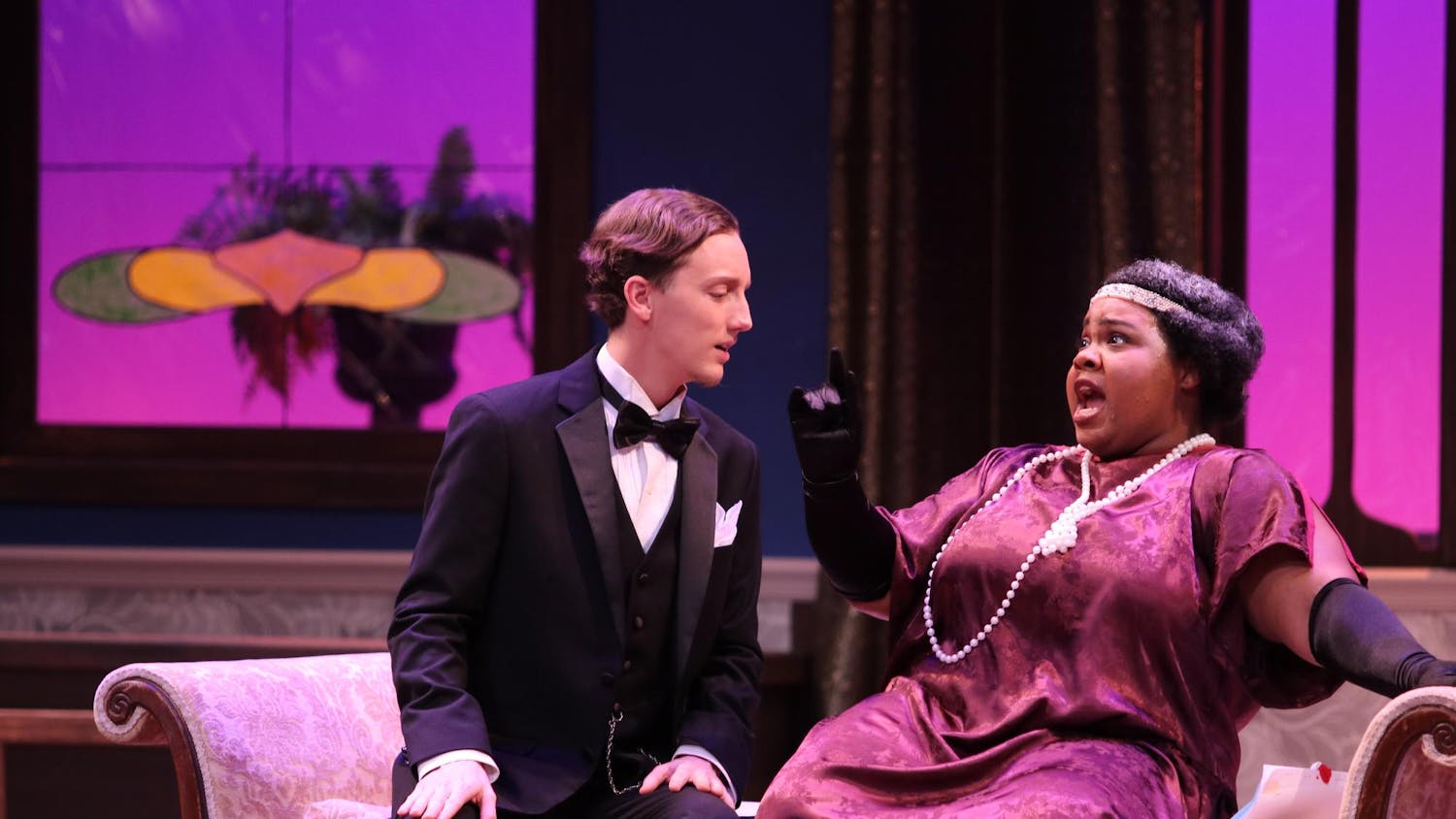 Second-year master of music opera theater student, Cydney Washington sings in character as Zita while University of South Carolina alumni Austin Means sits next to her on the couch prop on stage. The performance of this opera will take place in the Drayton Hall Theater from Feb. 28, 2025 to March 2, 2025.