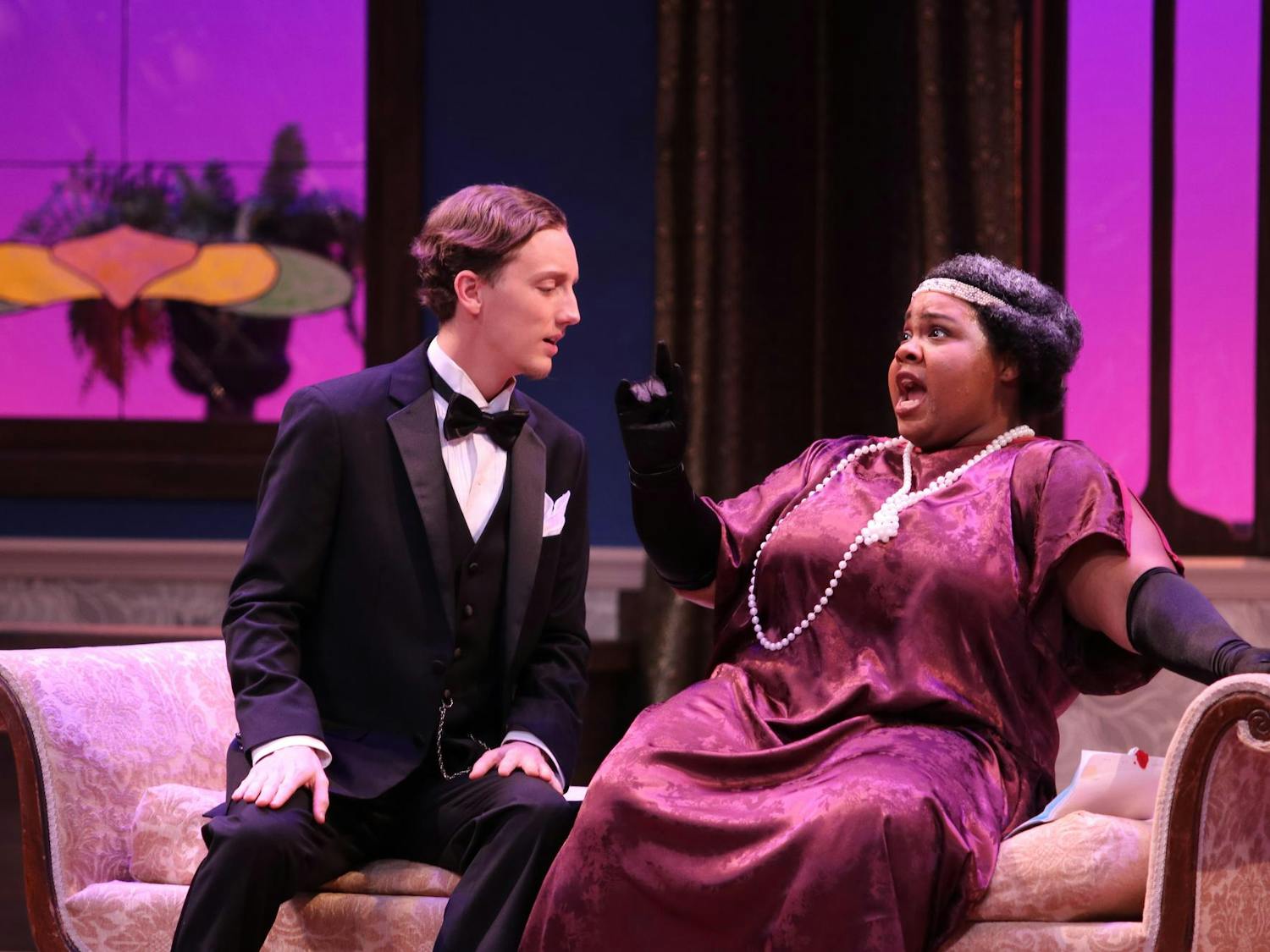 Second-year master of music opera theater student, Cydney Washington sings in character as Zita while University of South Carolina alumni Austin Means sits next to her on the couch prop on stage. The performance of this opera will take place in the Drayton Hall Theater from Feb. 28, 2025 to March 2, 2025.