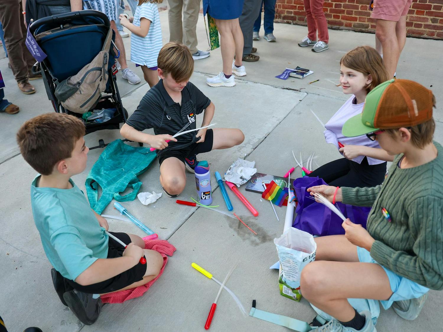 A group of children prepare light-up wands before the parade at the first night of the Famously Hot SC Pride Festival on Oct. 3, 2025. The kids marched with Shandon Presbyterian Church, one of several churches in attendance.