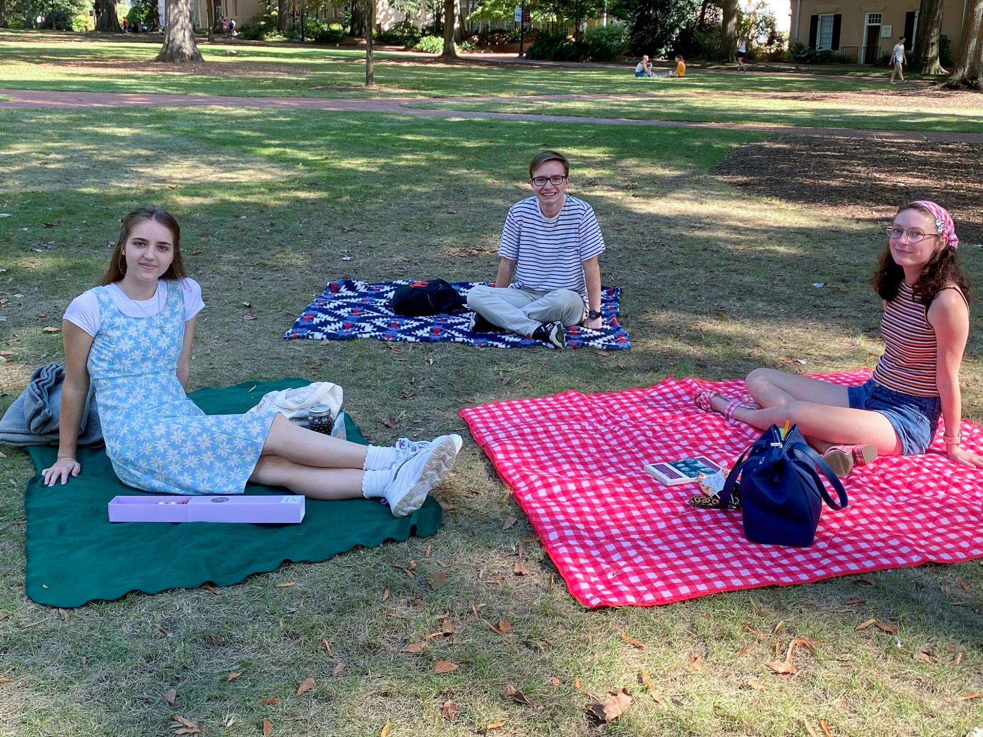 File— Three members of Delta Alpha Pi relax in the Horeshoe during their September Social Picnic on Sunday, Oct. 3, 2022. Delta Alpha PI is an academic honor society founded to create a community amongst high-achieving college students that deal with mental health challenges or other disabilities.