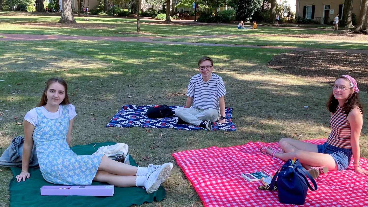File— Three members of Delta Alpha Pi relax in the Horeshoe during their September Social Picnic on Sunday, Oct. 3, 2022. Delta Alpha PI is an academic honor society founded to create a community amongst high-achieving college students that deal with mental health challenges or other disabilities.