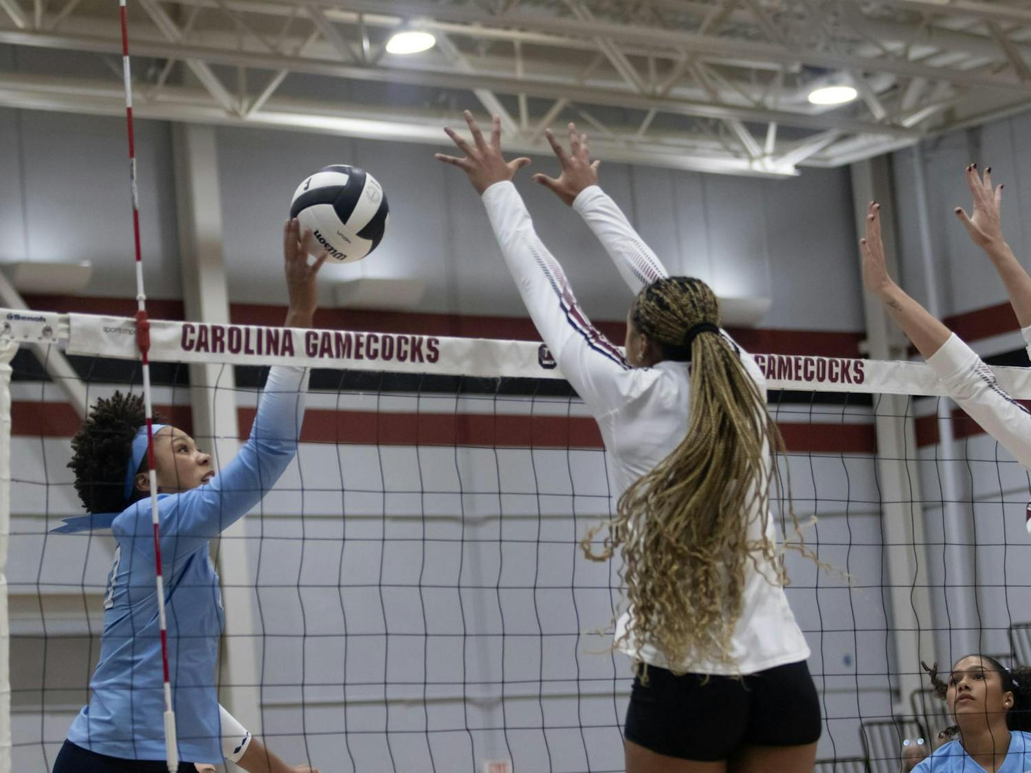 Freshman outside hitter Victoria Hill goes to block in a game against the University of North Carolina on Sept. 12, 2025, at the Carolina Volleyball Center. In addition to volleyball, Hill competed on the track and field team at Trinity Prep.