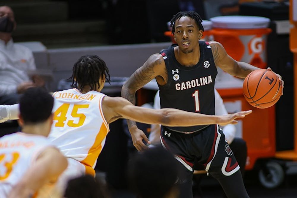 <p>Red shirt sophomore guard TJ Moss dribbles the ball while looking at a Tennessee player. South Carolina lost 93-73.</p>
