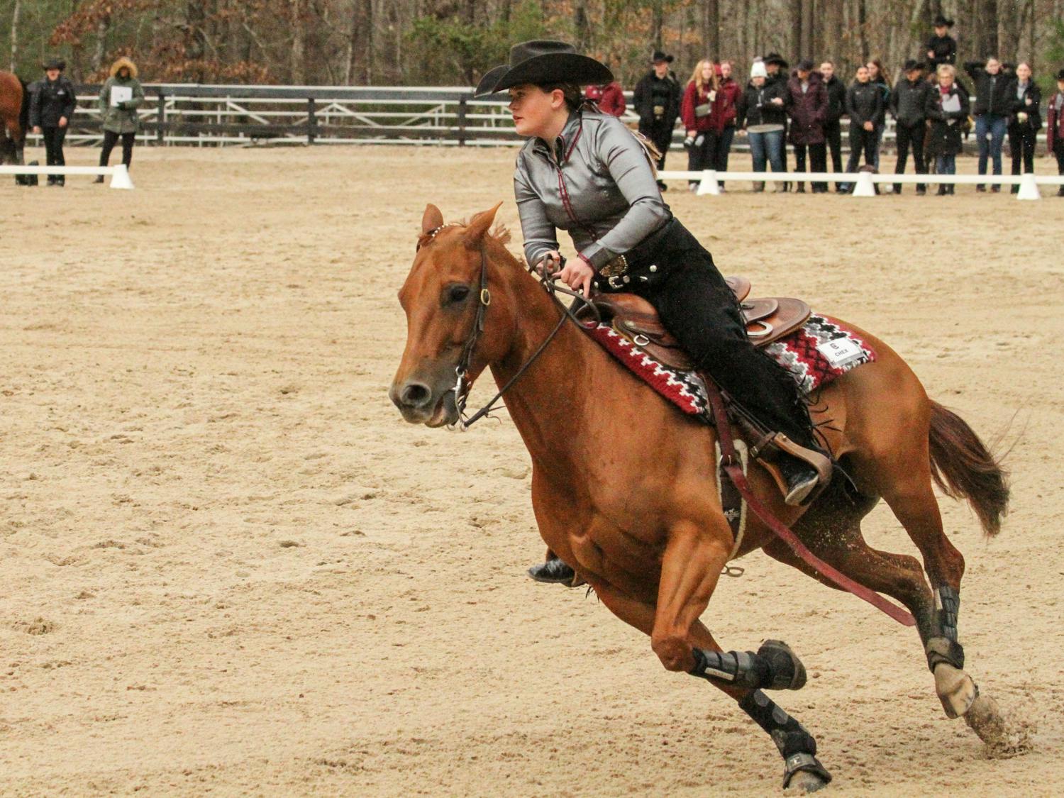 Senior Mary Margaret Coats, mounted on Chexie, competes in the reigning category during the meet against Texas A&amp;M at One Wood Farm on Feb. 11, 2023. In NCEA competition, you draw what order you compete in and ride the same horse as your opponent. Of all the horses at One Wood Farm, the one named Magnum is one of Coats' favorites. “(I) won my point on him several times,” Coats said. “He is a good boy every time, and he loves being a Gamecock.”&nbsp;