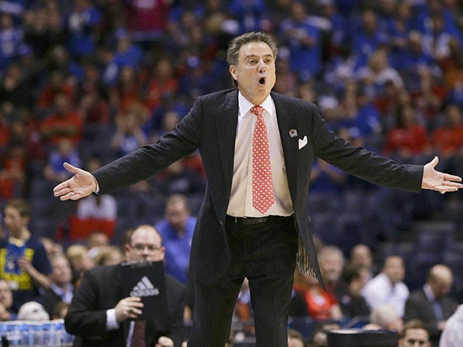 Louisville head coach Rick Pitino questions a call during action against Kentucky in the NCAA Tournament&apos;s Midwest Region semifinal at Lucas Oil Stadium in Indianapolis on Friday, March 28, 2014. (Mark Cornelison/Lexington Herald-Leader/MCT)