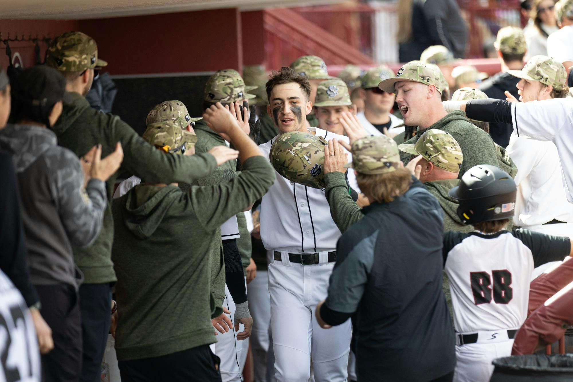 A Gamecock baseball player celebrates in the dugout in Founder's park on Feb. 16, 2025. The Gamecocks celebrated a 8-0 win against Sacred Heart during opening weekend 2025.