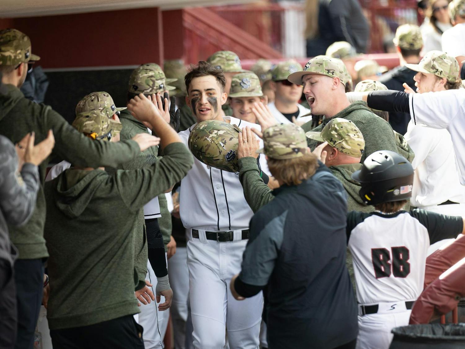 A Gamecock baseball player celebrates in the dugout in Founder's park on Feb. 16, 2025. The Gamecocks celebrated a 8-0 win against Sacred Heart during opening weekend 2025.