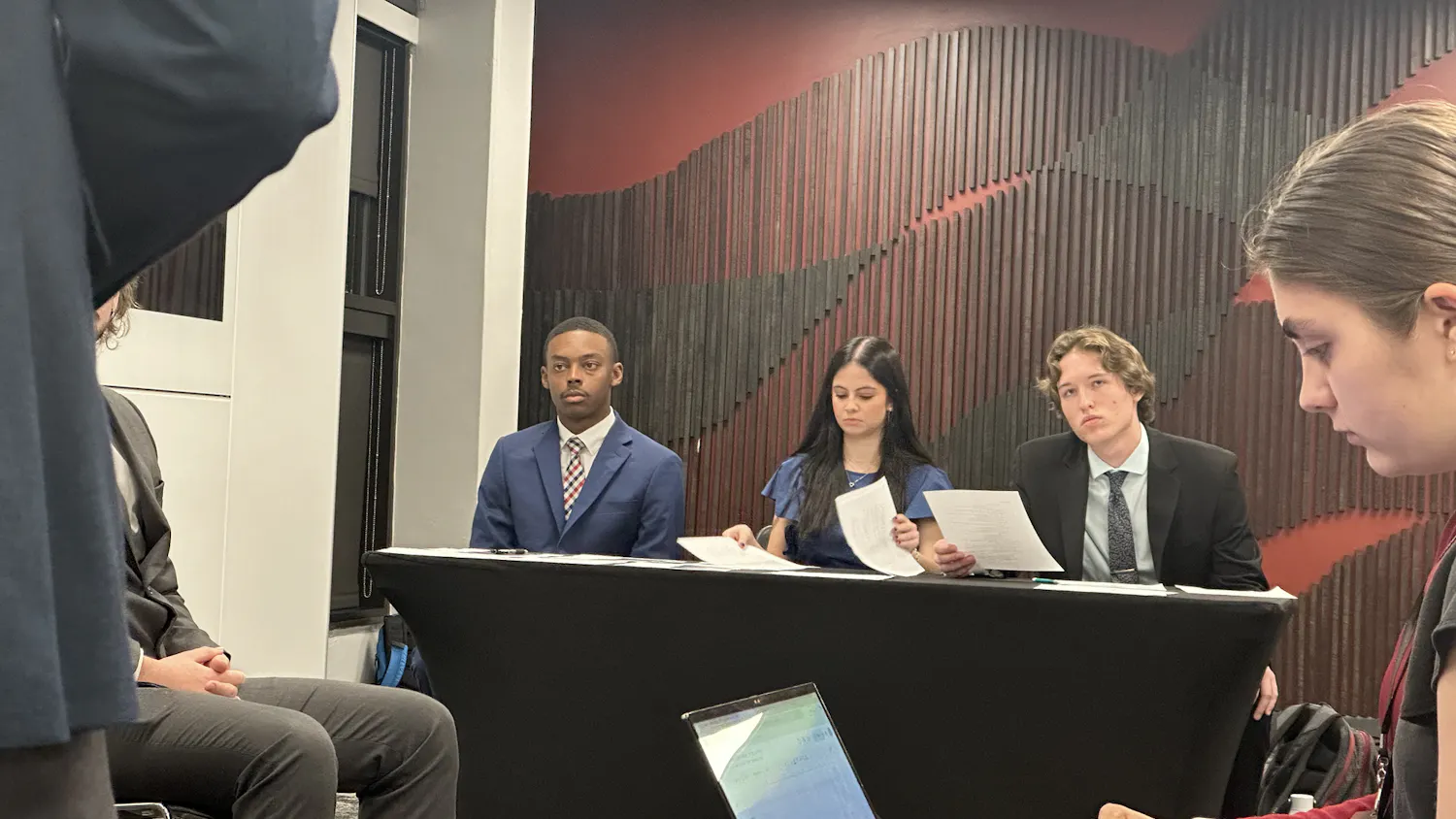 Student body vice presidential candidate Jordan Richardson sits beside his counsel consisting of second-year entertainment law student Nicole Gleicher and second-year political science student Tyler Frintner. This hearing was held in Russell House room 322 on Feb. 27.