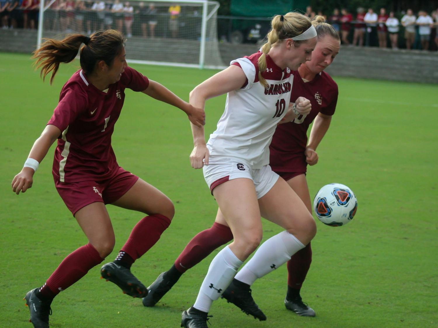 Junior forward Catherine Berry fights off defenders in pursuit of a goal during a women's soccer game Thursday afternoon, August 18, 2022. USC tied against FSU 0-0.