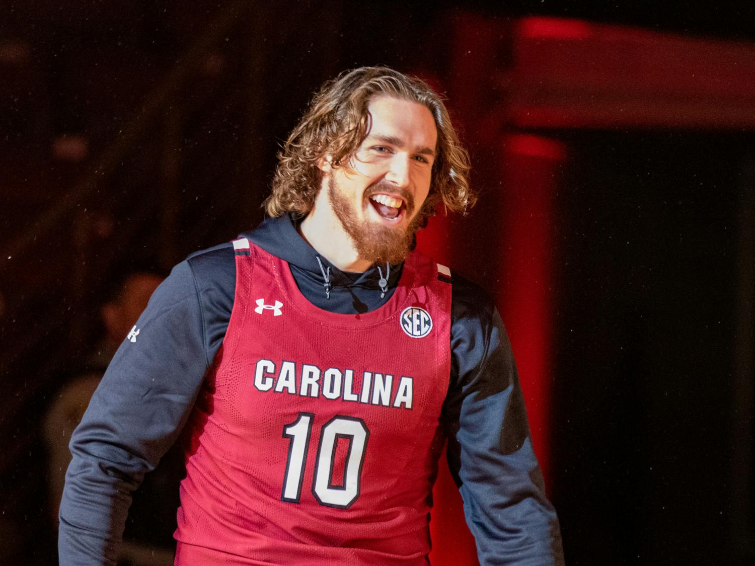 Graduate student forward Hayden Brown smiles as he steps on the court after being introduced to the small crowd on Oct. 26, 2022. The Gamecocks men's basketball team hosted the Garnet &amp; Black Madness event, including a scrimmage, dunk contest and three-point contest.
