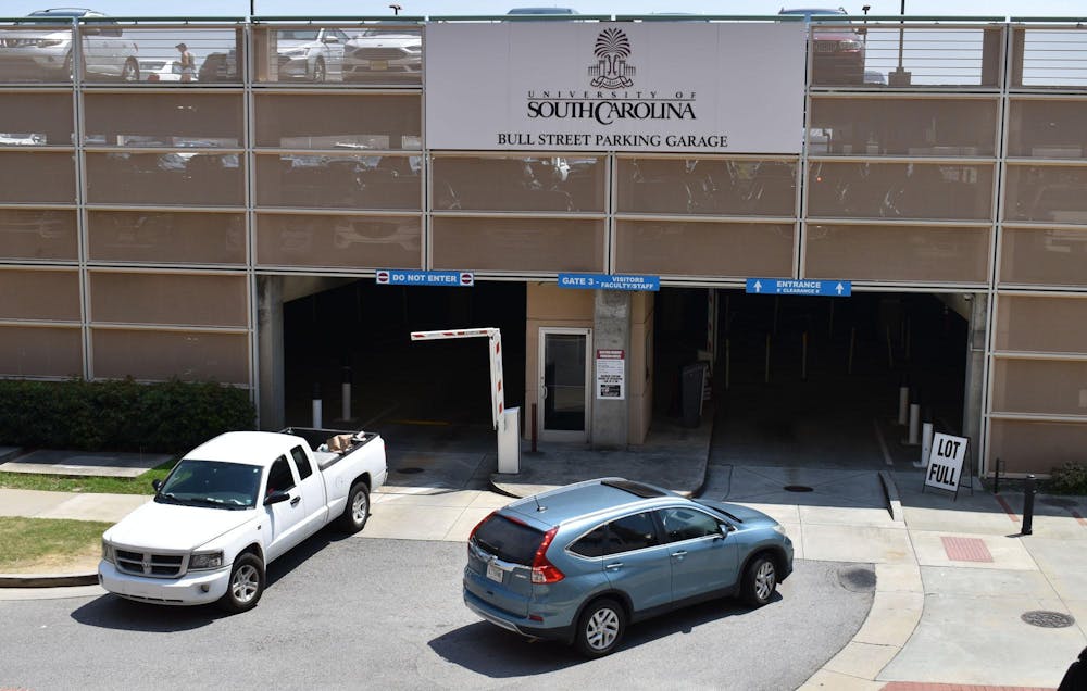 <p>Vehicles enter and exit Bull Street Garage on Aug. 24, 2023. USC students are required to have a permit or pass to park at designated lots and garages, including Bull Street.</p>