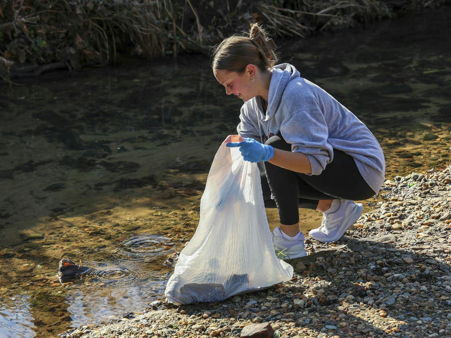 Second-year Russian and environmental studies student Allison Desmarais cleans up trash from Maxcy Gregg Park on Feb. 2, 2024. Desmarais formed the club as an accessible way for students to do community service work.