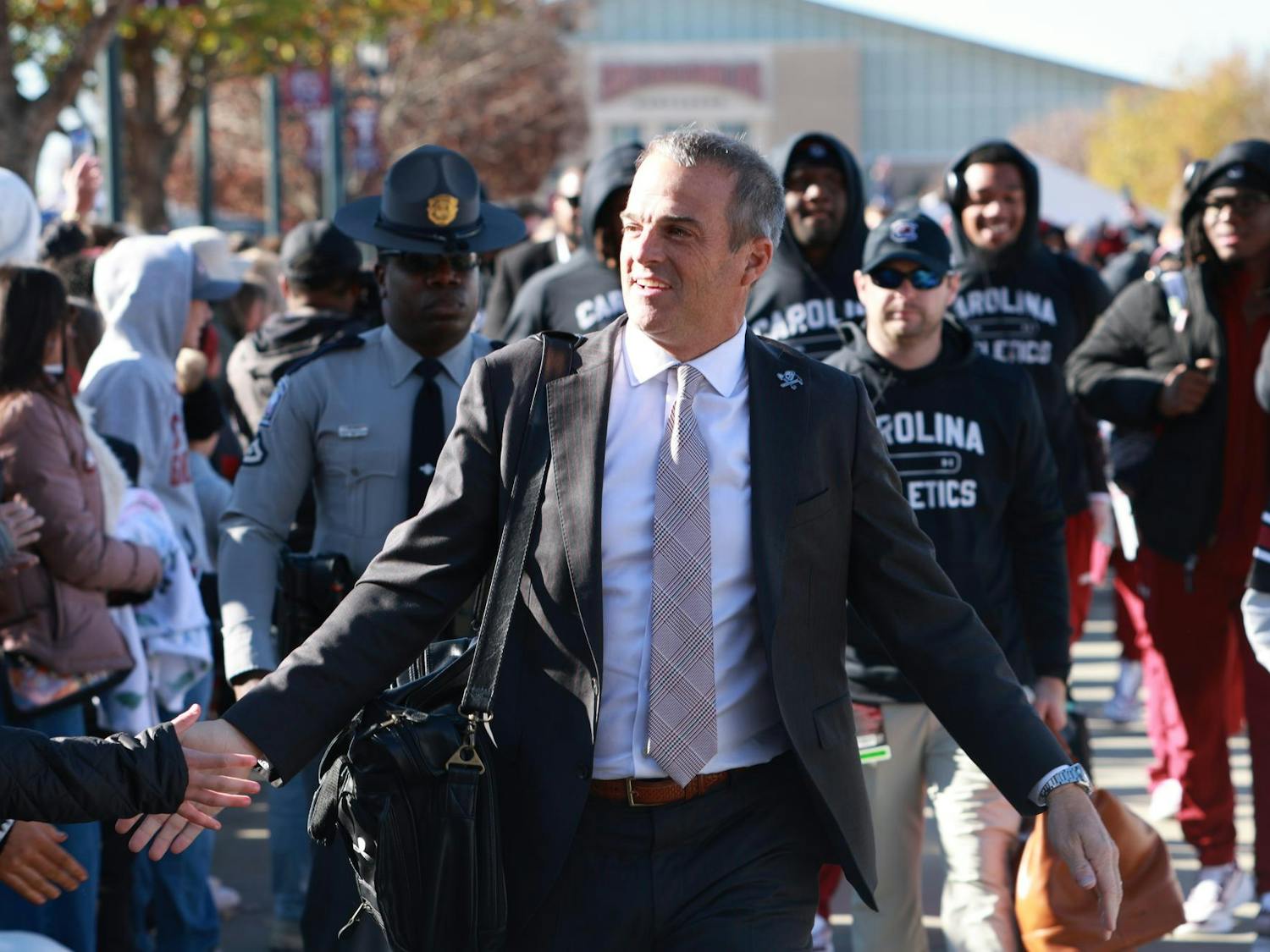 South Carolina head coach Shane Beamer walks through Gamecock Park and greets fans before the matchup against Clemson on Nov. 29, 2025. Beamer leads the team down the pathway as supporters line the route for the traditional pregame walk.