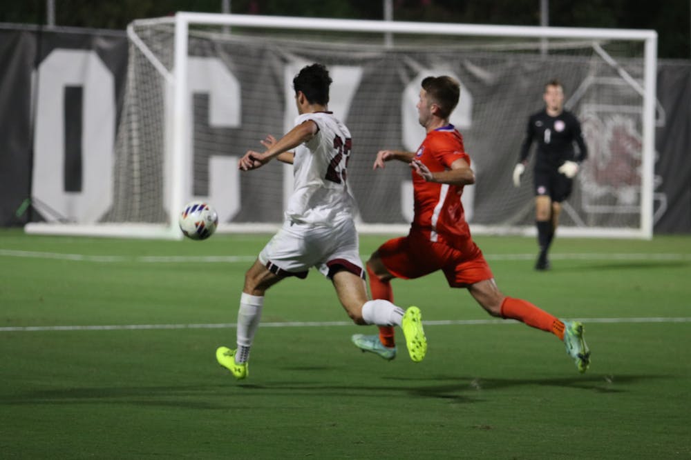 <p>Sophomore forward Harrison Myring chasing down the ball during South Carolina's 1-0 loss to Clemson on Sep. 2, 2022.</p>