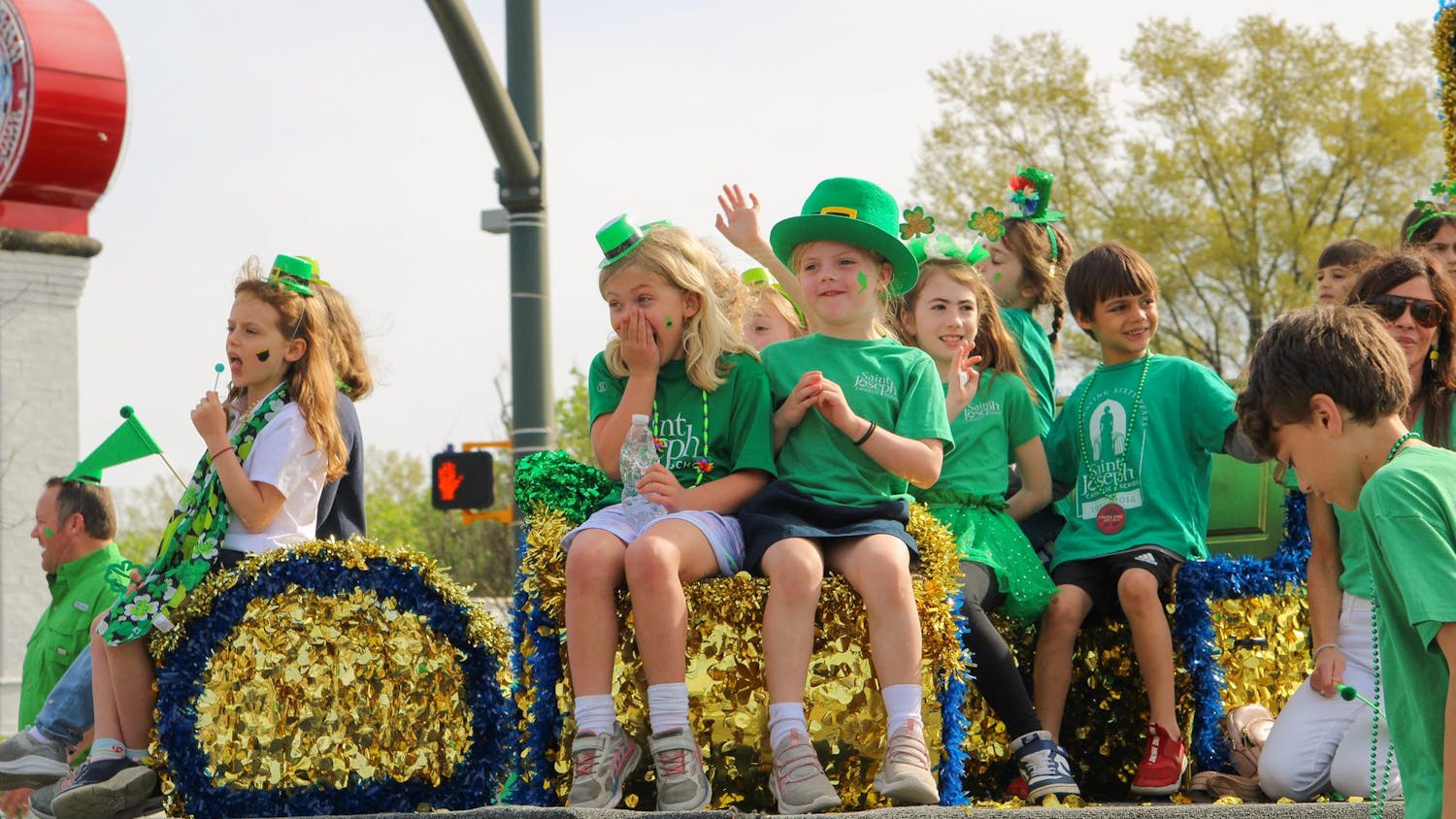 FILE — Children greet the crowd as they walk in the St. Pat’s in Five Points parade on March 16, 2024. The parade is part of an annual all-day festival full of St. Patrick’s Day festivities in Five Points.